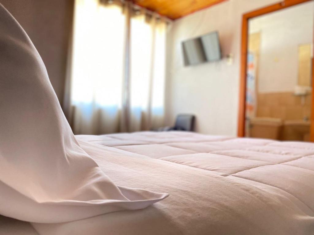 Llit o llits en una habitació de Hotel Vidal