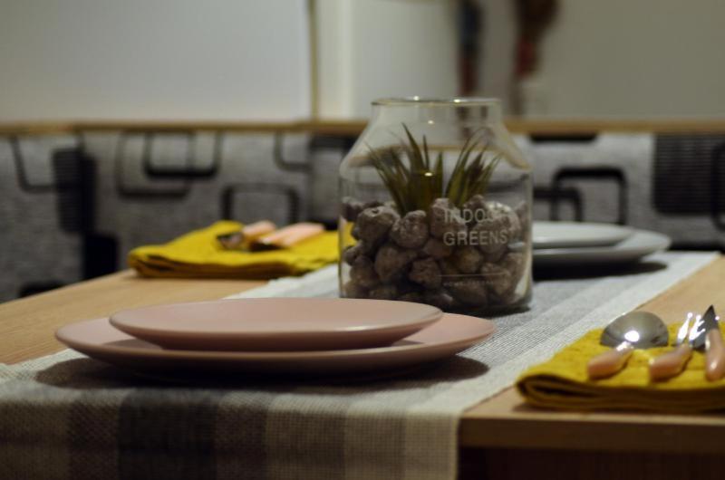 a table with two plates and a jar of food at Apartament Thea in Făgăraş