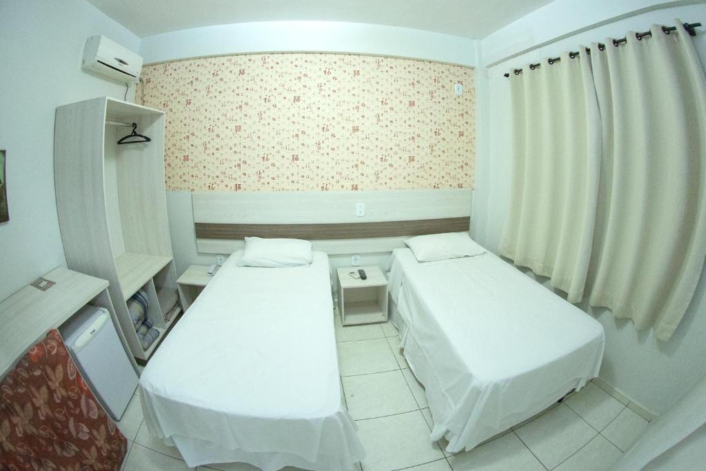 Postel nebo postele na pokoji v ubytování Hotel Sambakia