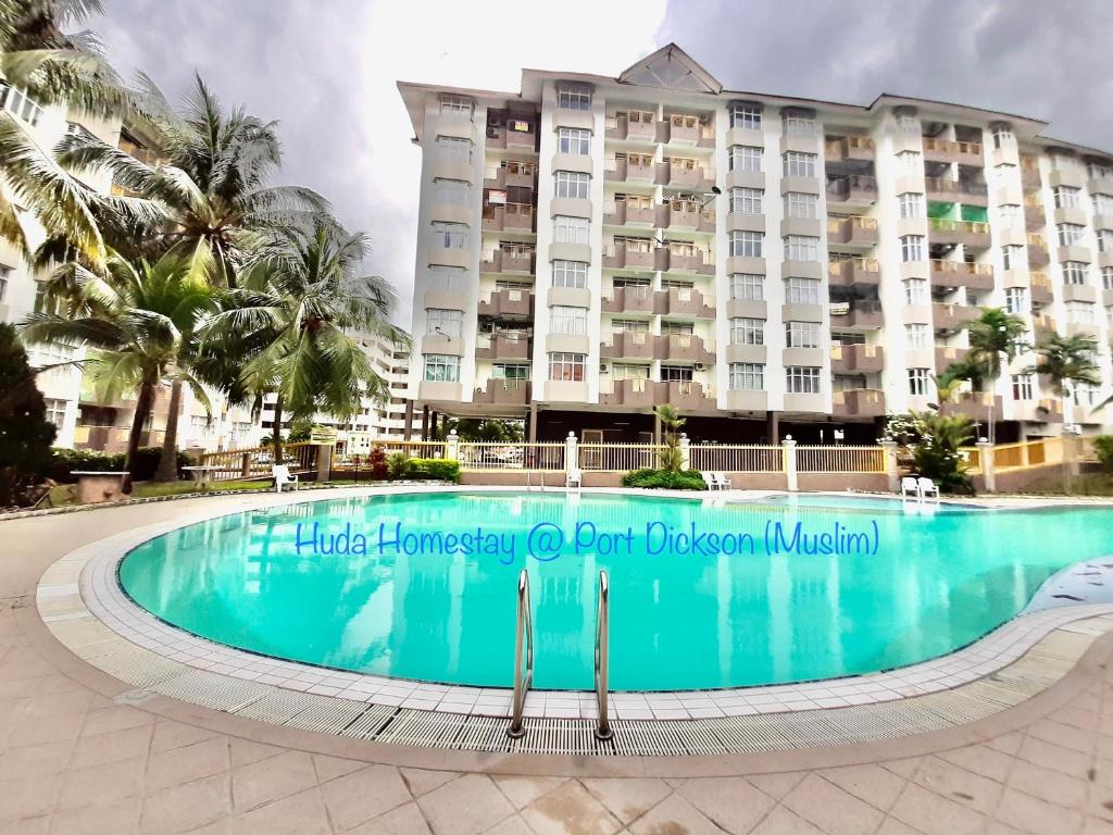 une piscine en face d'un hôtel dans l'établissement Huda Homestay @ Port Dickson, à Port Dickson