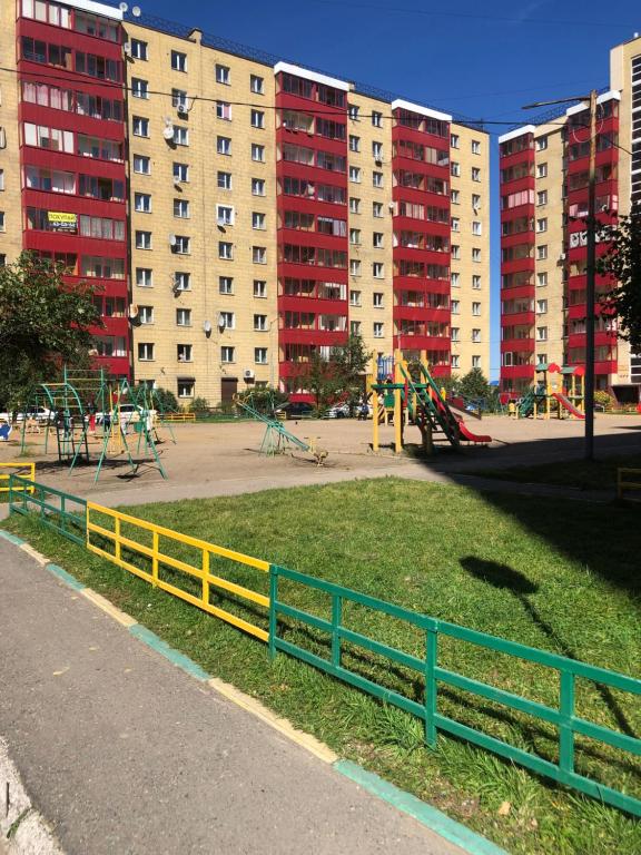 a park with a yellow fence and a playground at 2х-комнатная на берегу Ангары in Irkutsk