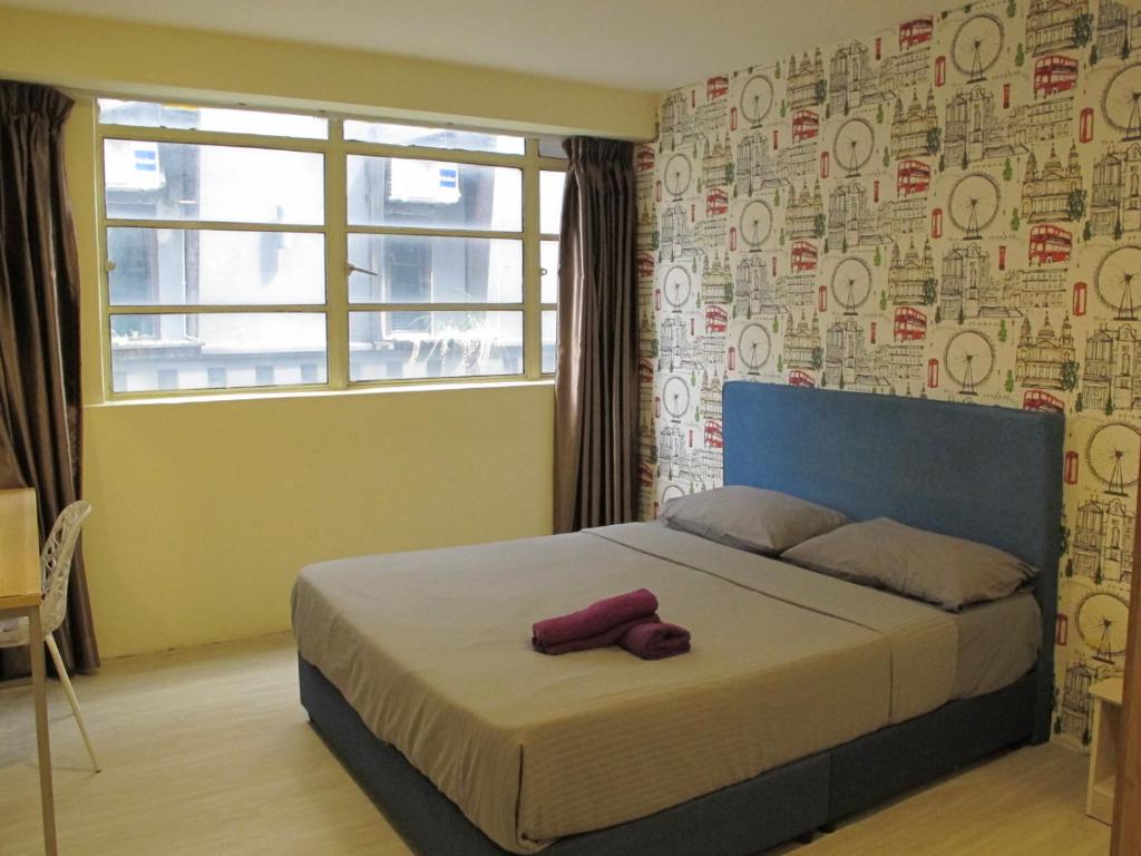 a bedroom with a bed with a teddy bear on it at Oscar Inn in Petaling Jaya