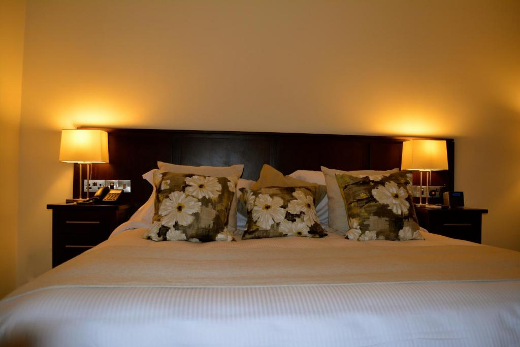 Postel nebo postele na pokoji v ubytování New Brookfields Hotel