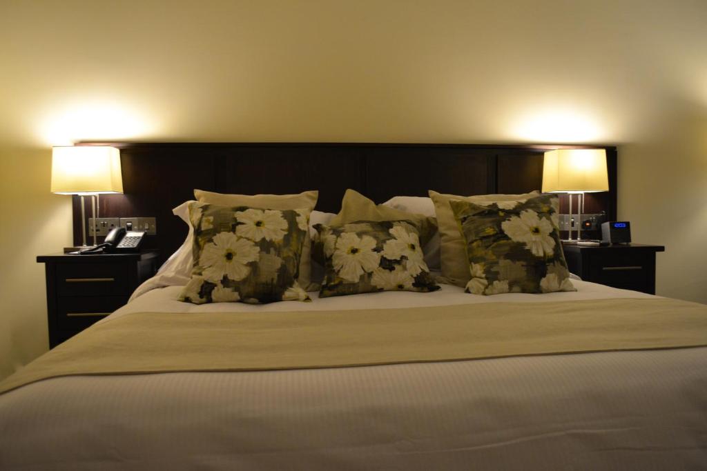 Postel nebo postele na pokoji v ubytování New Brookfields Hotel