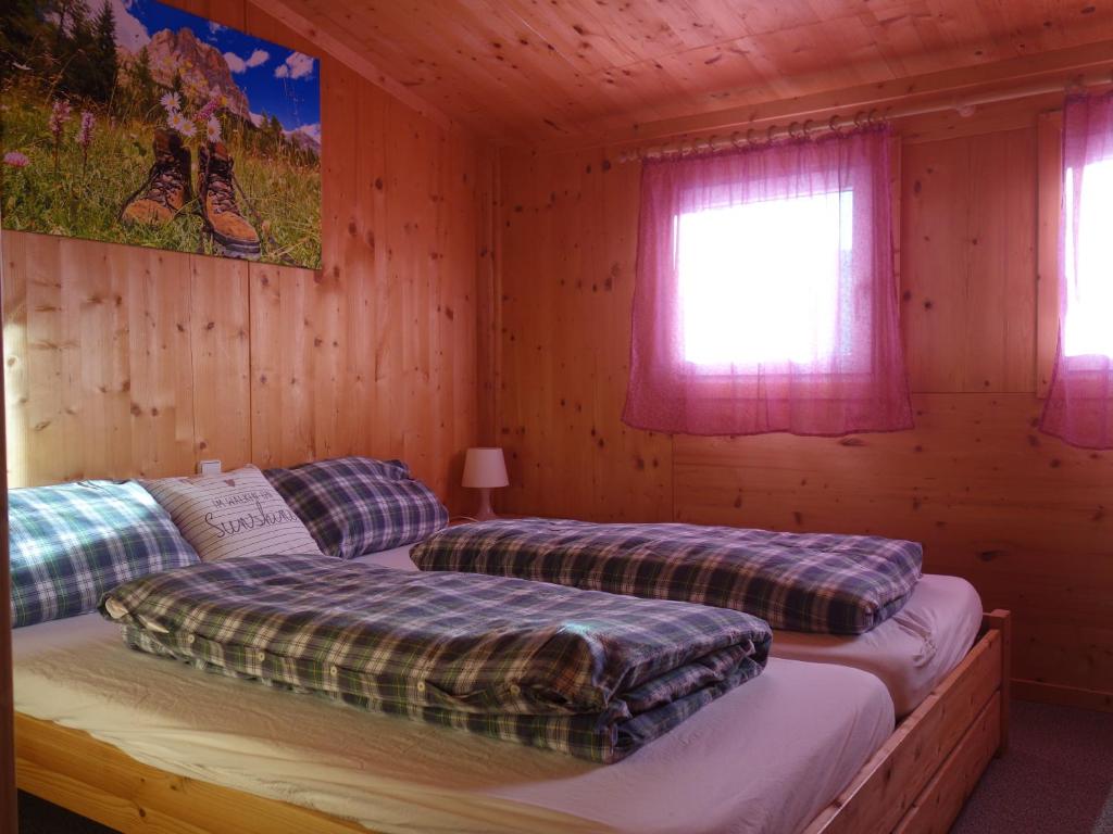 Postel nebo postele na pokoji v ubytování Feriendorf Tauerngast
