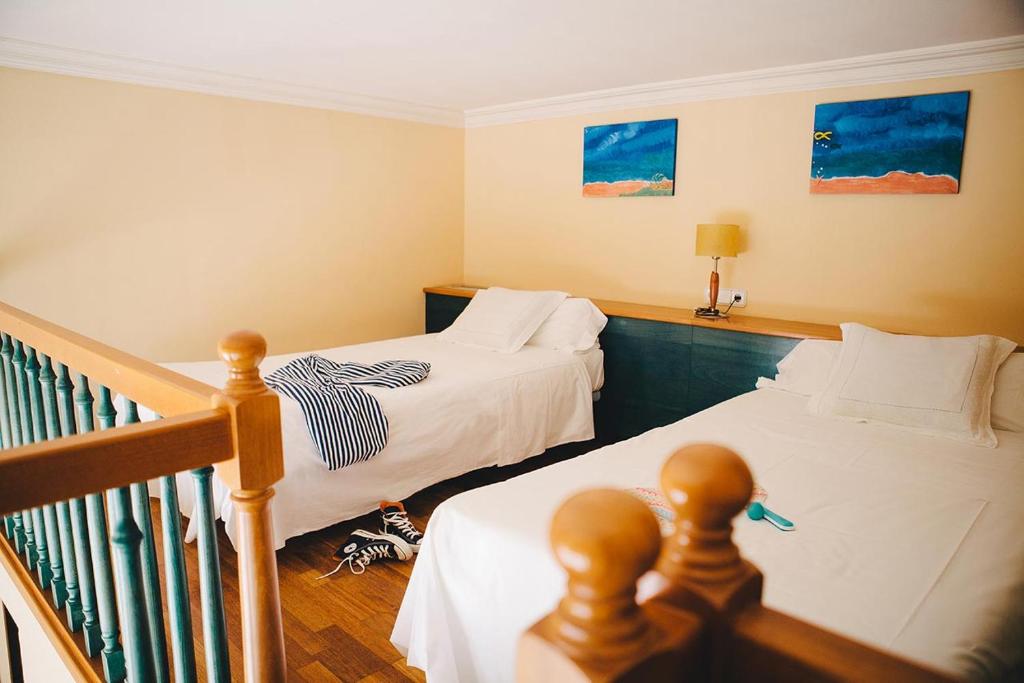 A bed or beds in a room at MAREA Hotel