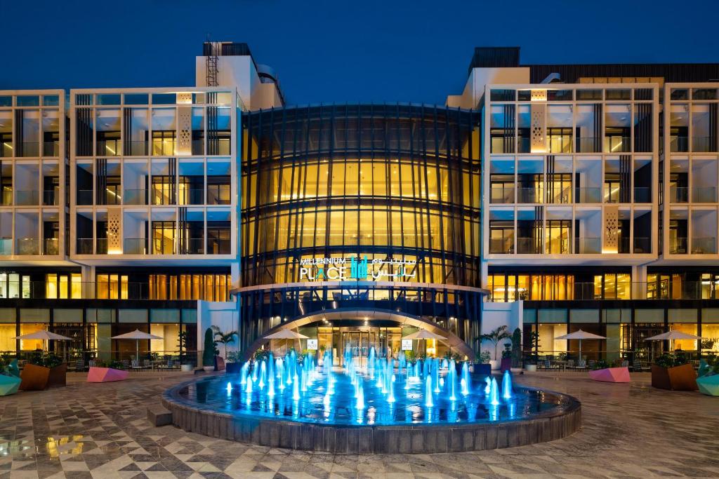 a building with a fountain in front of it at Millennium Place Mirdif in Dubai