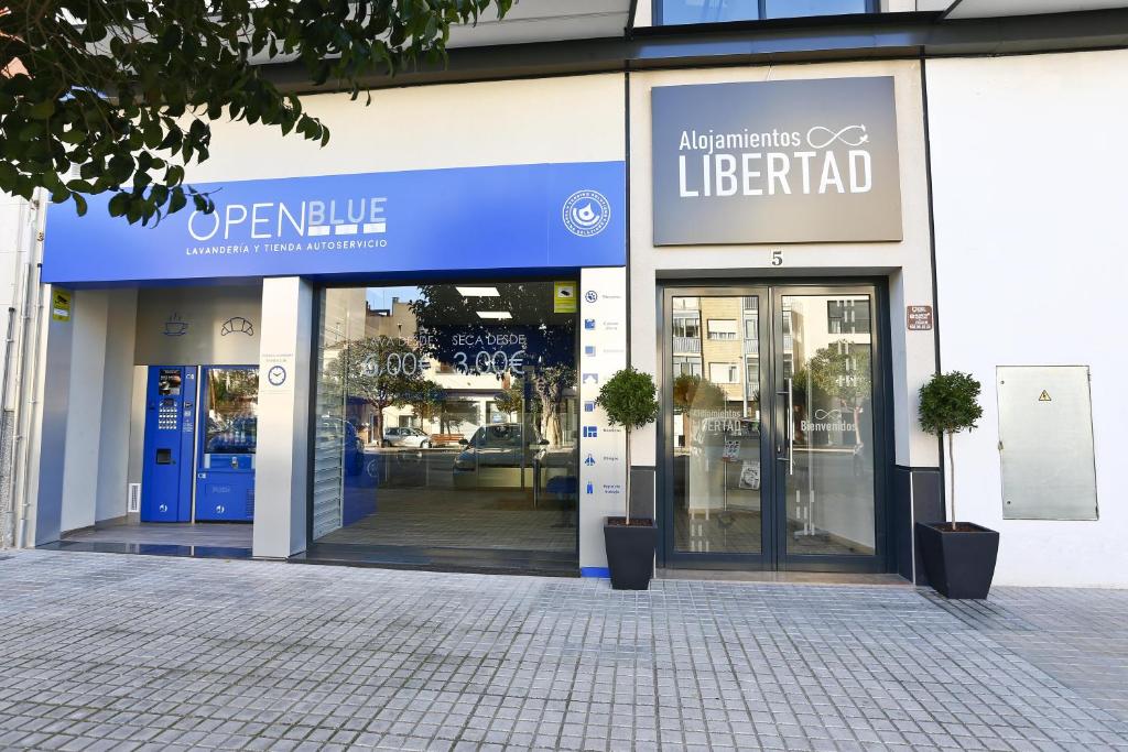 a building with a sign on the front of it at Alojamientos Libertad in Yecla