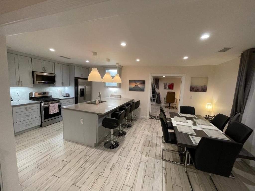 a kitchen and dining room with a table and chairs at Cheerful, Beautifully Remodeled, Modern, Comfortable Home in Los Angeles