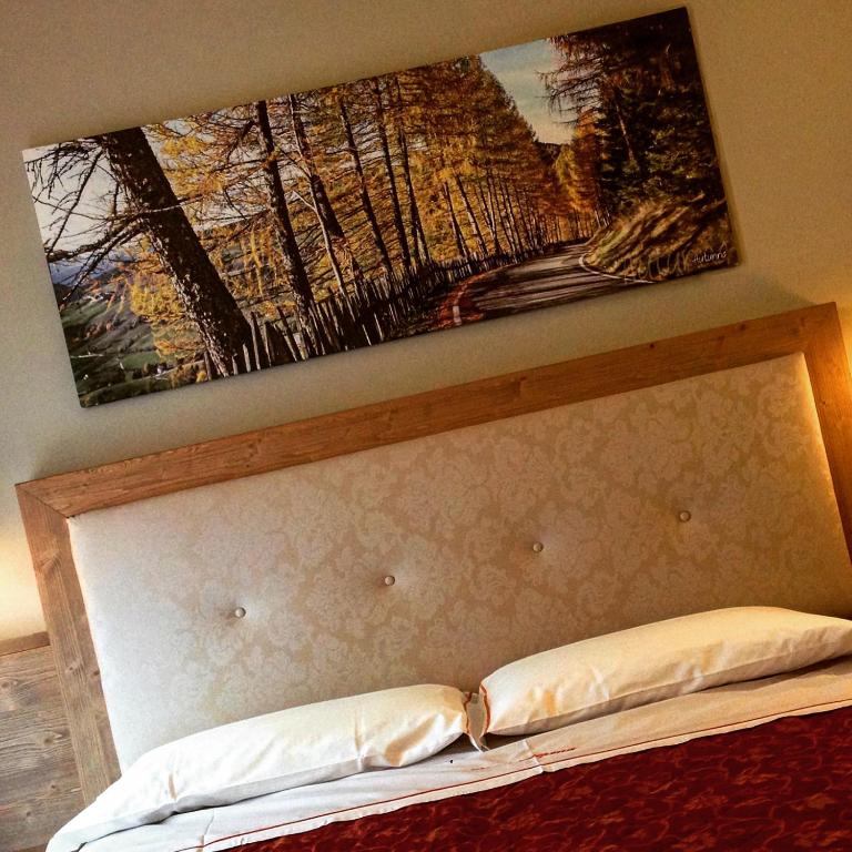 Postel nebo postele na pokoji v ubytování Hotel Alpina