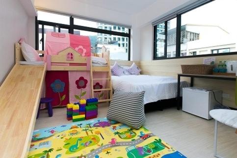 a room with a bedroom with a bed and a rug at Meng Yun Ge Hotel in Jiaoxi