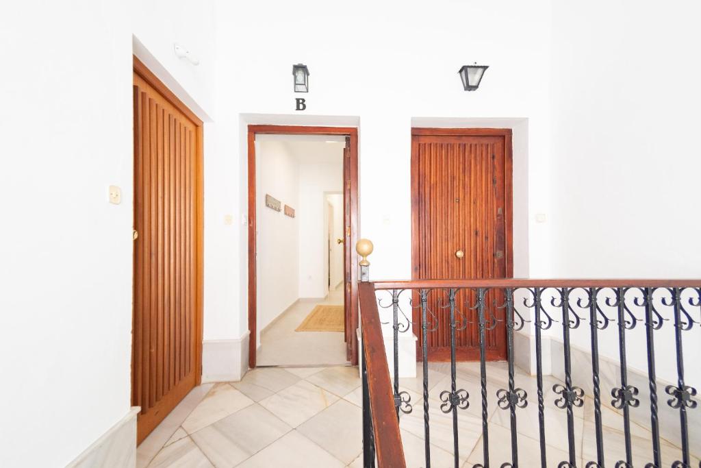 a hallway of a house with a staircase and a door at Apartamento Centro Calle Plata in Sanlúcar de Barrameda