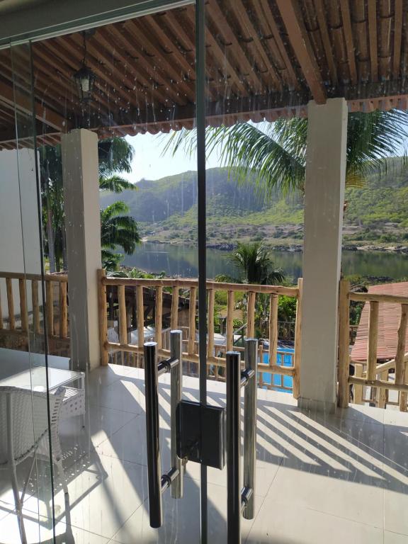 a view of the water from the balcony of a house at Casa Temporada Waldemar Damasceno - Beira Rio com piscina in Piranhas