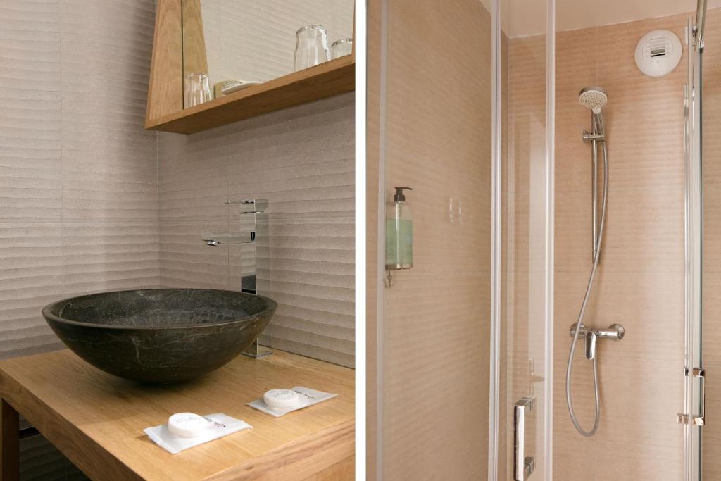 a bathroom with a black sink and a shower at Hotel Le Dauphin in Honfleur