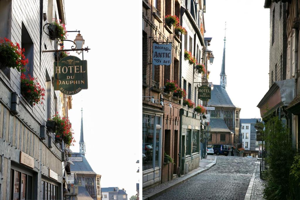 a street scene with buildings and a street sign at Hotel Le Dauphin Les Loges in Honfleur