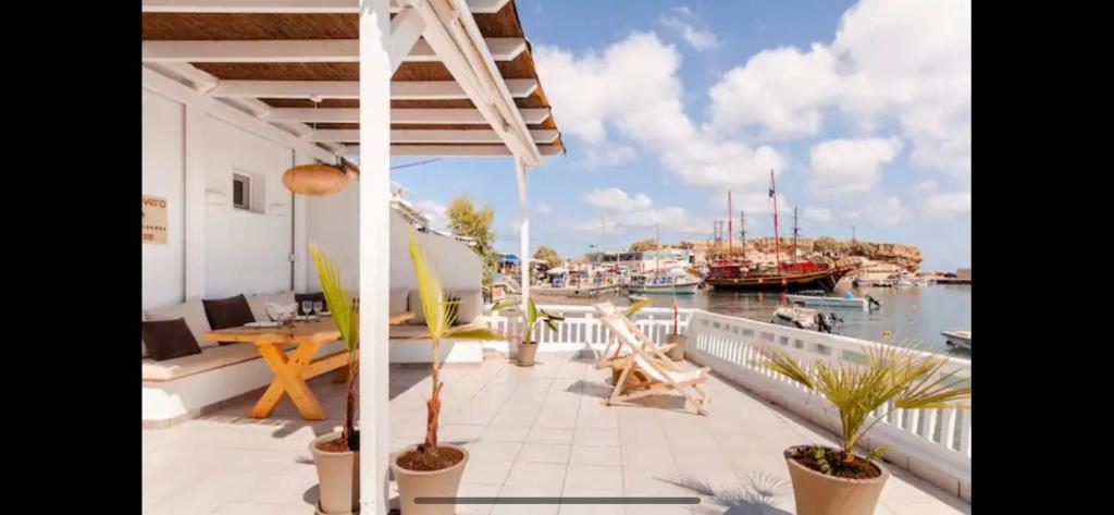 a balcony with a view of a marina with boats at Aqua Vero Seaside Residence in Hersonissos