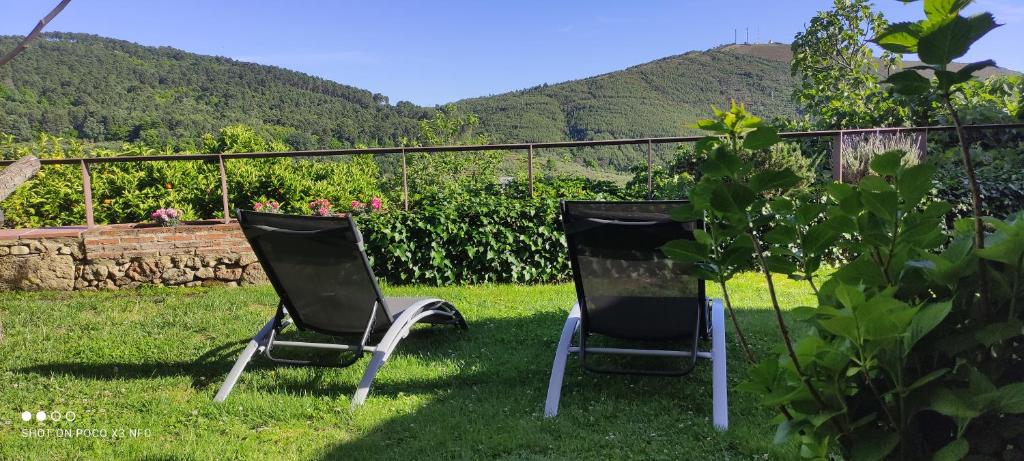 zwei Stühle im Gras im Garten in der Unterkunft Zocailla in Gata