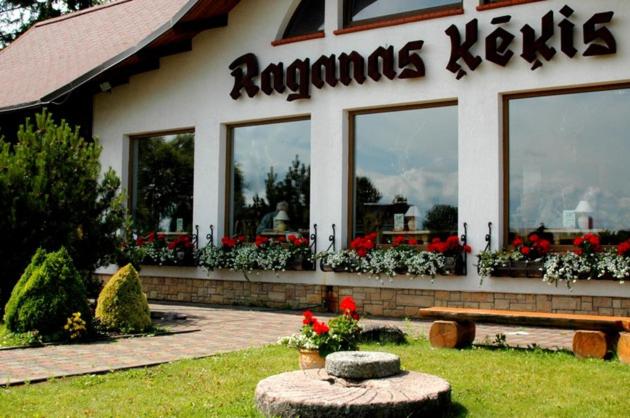 Restaurante aania kettles com um banco à frente. em Raganas Ķēķis Hotel em Ragana