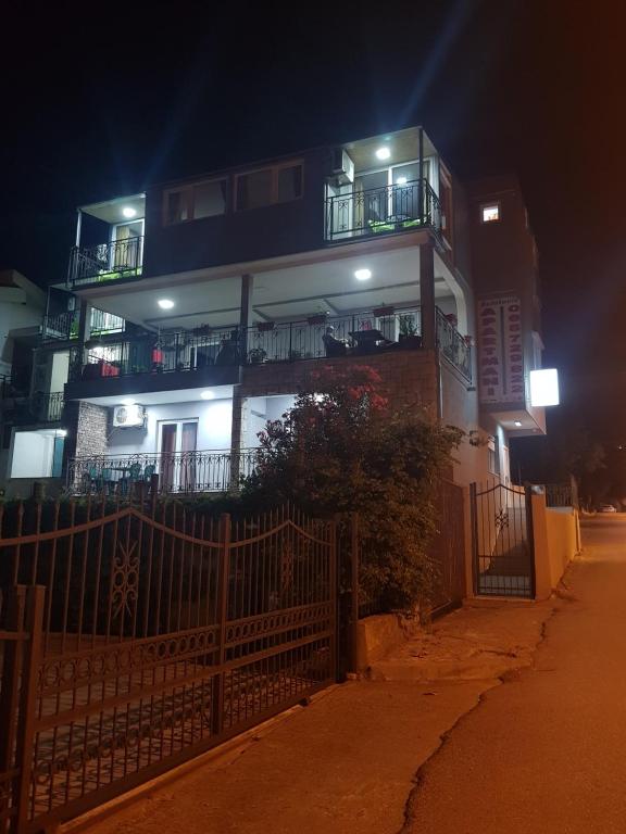 a building with balconies on the side of it at night at Apartments Bulatović in Bar