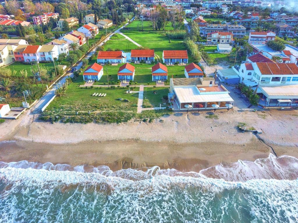 an aerial view of a beach with houses and the ocean at Beachside Bungalows Acharavi Corfu in Acharavi