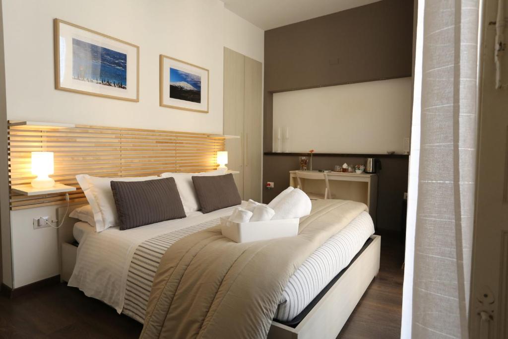 a bedroom with a large bed with a box on it at Mavà in Catania