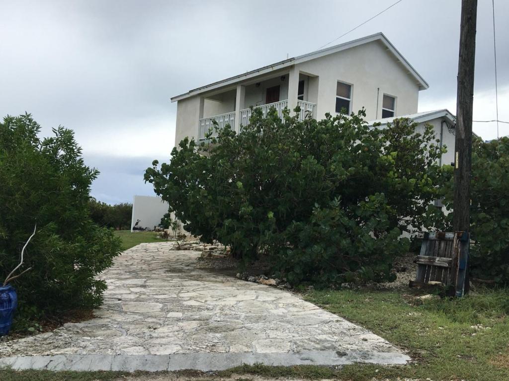 Biały dom z krzakami przed nim w obiekcie La Grande Pettite Villa w mieście Grand Turk Island