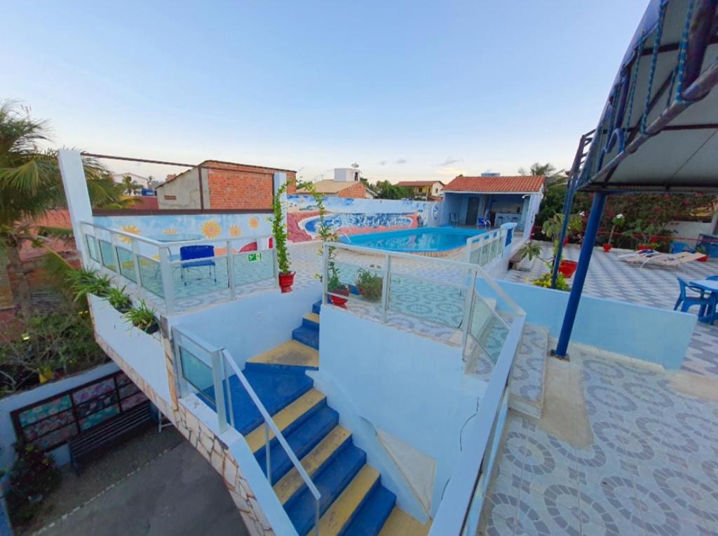 a set of stairs leading to two swimming pools at Pousada Azul in Canoa Quebrada