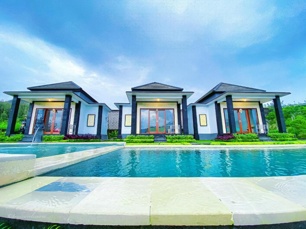 a house with a swimming pool in front of it at Bali Astetic Villa and Hot Spring in Kintamani