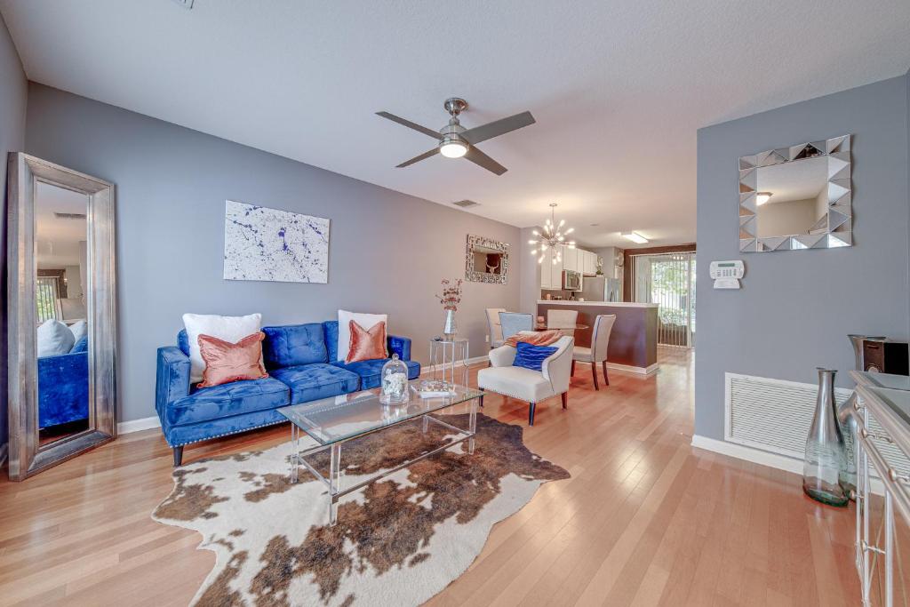 a living room with a blue couch and a table at The Lux At Lake Mary in Lake Mary