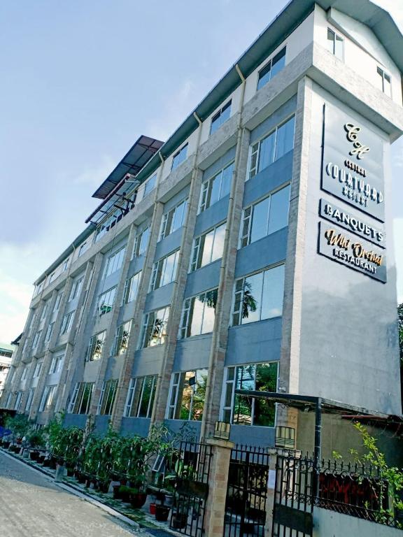 a building with a sign on the side of it at Central Courtyard Boutique Hotel in Siliguri