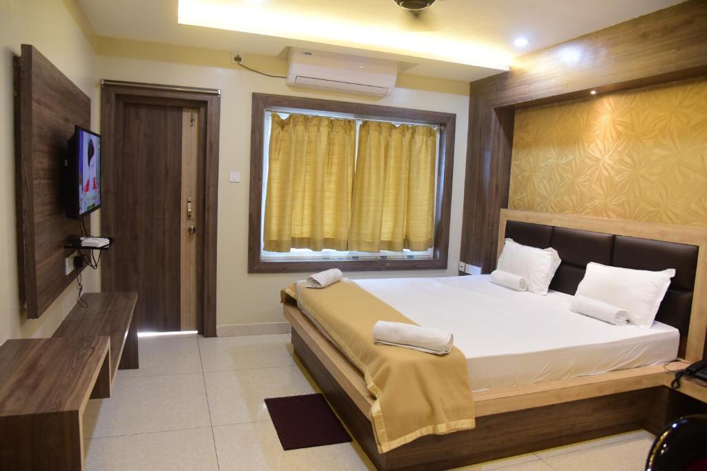 Postel nebo postele na pokoji v ubytování Hotel Guru Estate