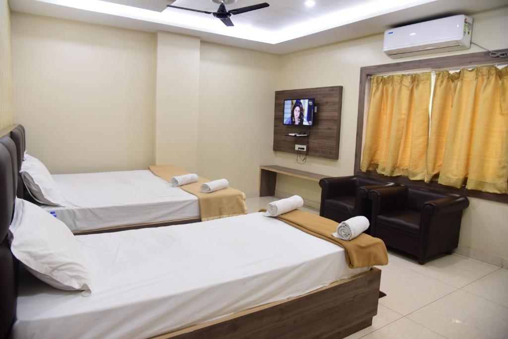 Postel nebo postele na pokoji v ubytování Hotel Guru Estate