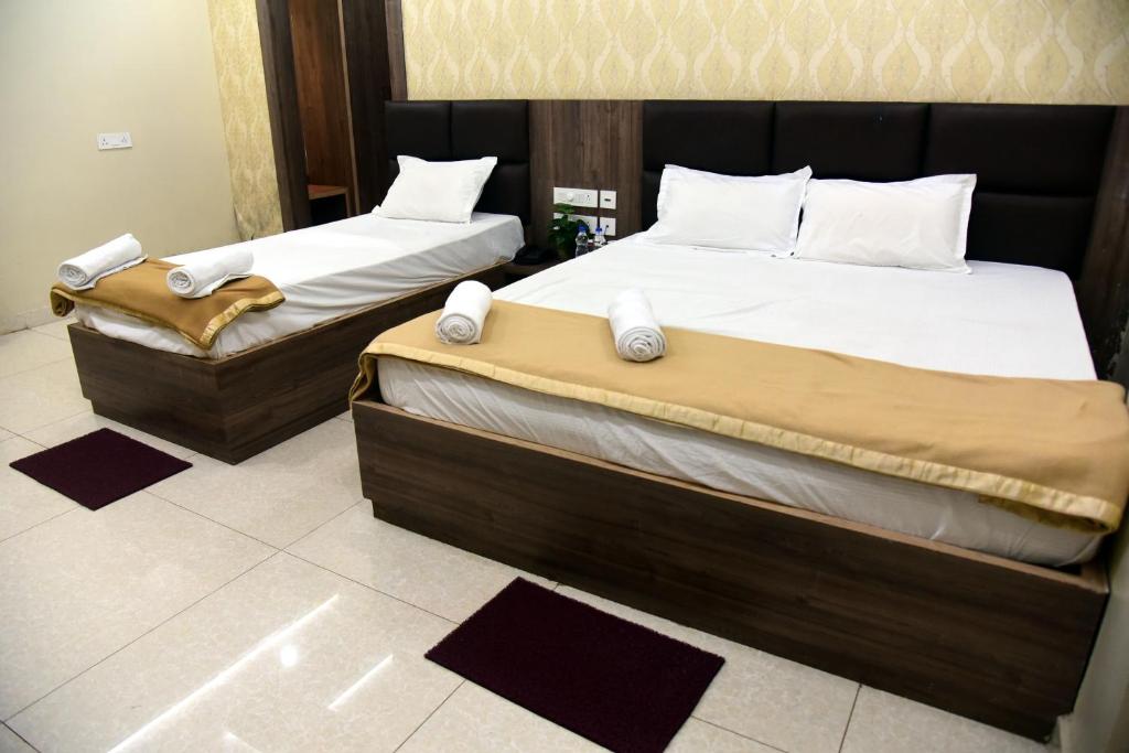Postel nebo postele na pokoji v ubytování Hotel Guru Estate