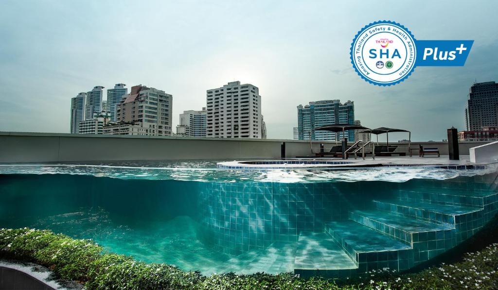 a large body of water with a clock on it at S31 Sukhumvit Hotel - SHA Extra Plus in Bangkok