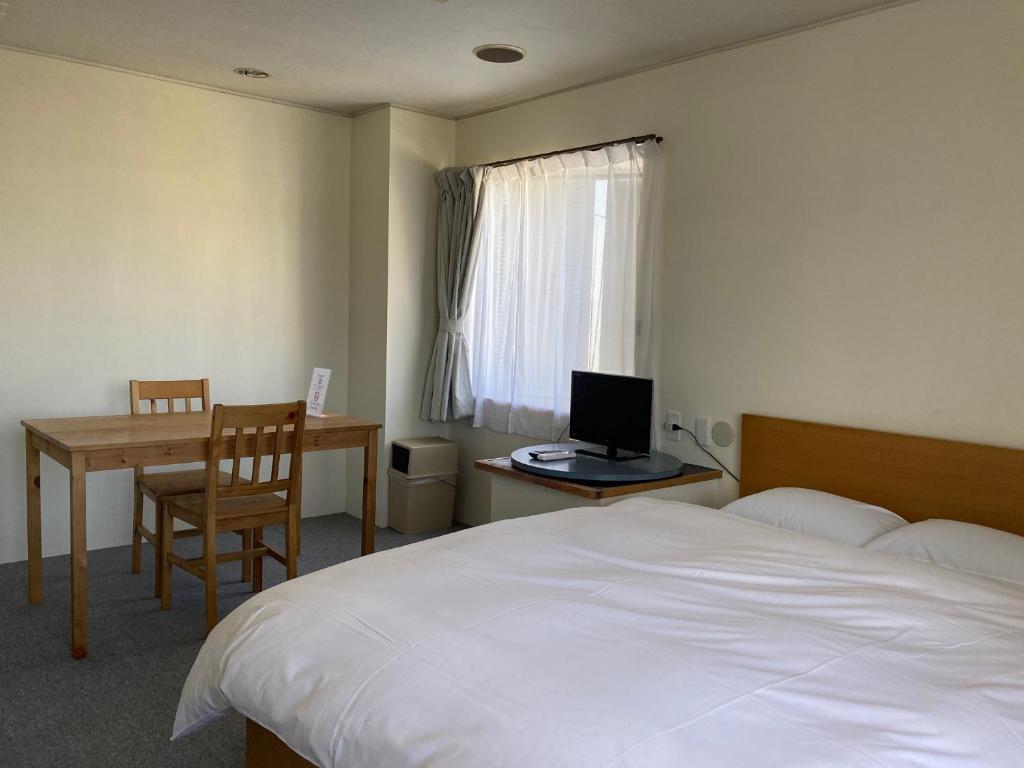 Postel nebo postele na pokoji v ubytování J-Hoppers Beppu Guesthouse ジェイホッパーズ別府ゲストハウス