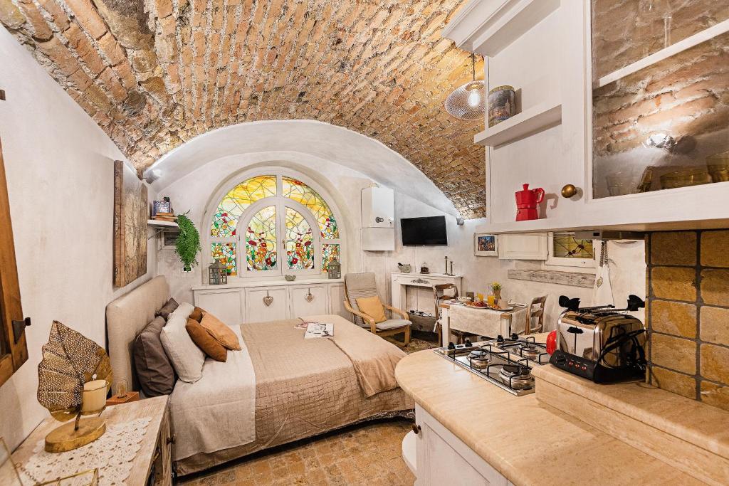 um quarto com uma cama e uma cozinha com um fogão em C'era una volta in centro by Wonderful Italy em Desenzano del Garda