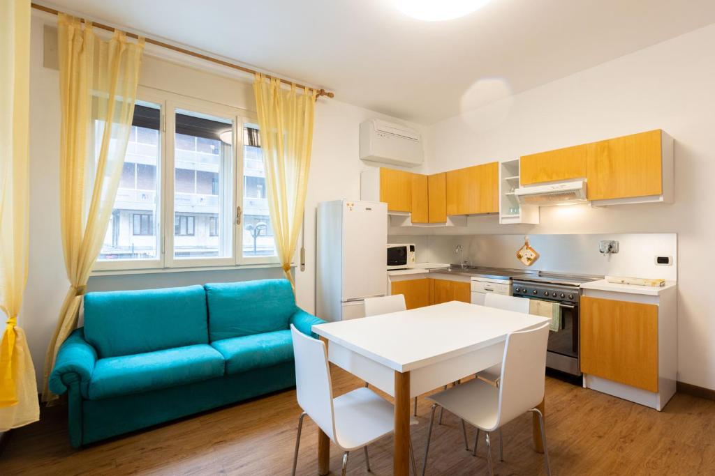 a kitchen with a blue couch and a table at Lame, Bologna by Short Holidays in Bologna