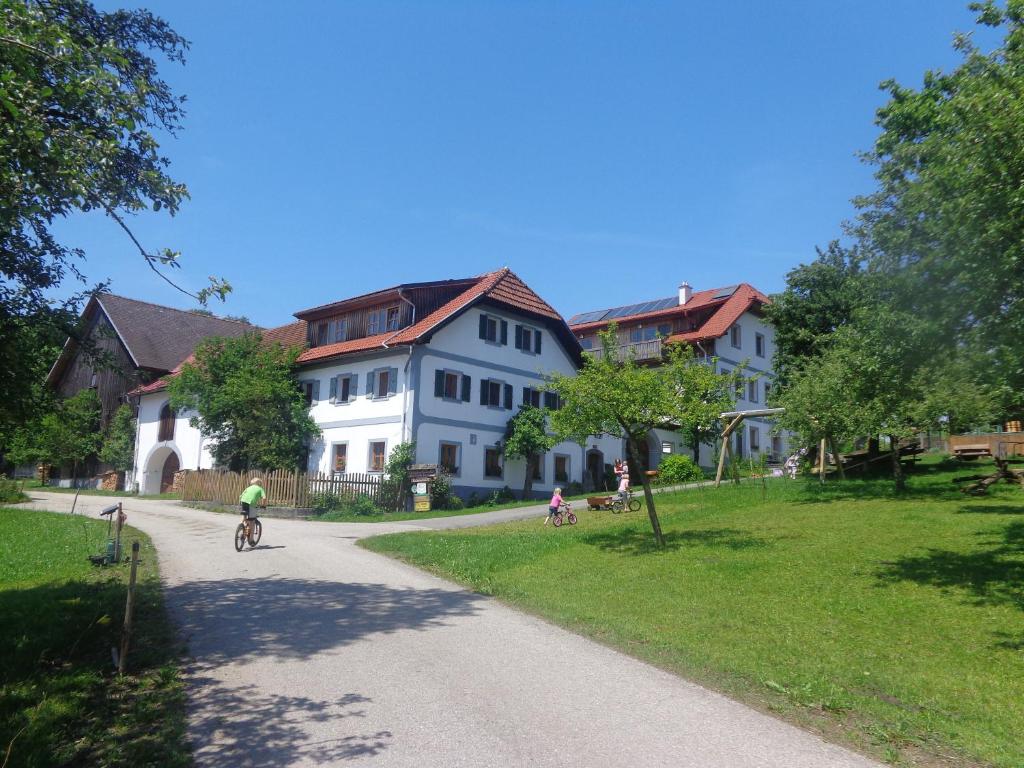 a group of people riding bikes down a road next to houses at Biohof Stadler in Neustift im Mühlkreis