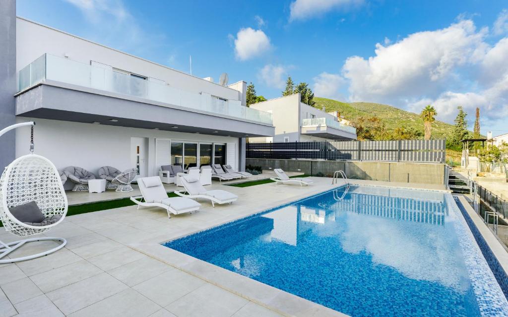 a villa with a swimming pool and a house at Luxury Blue Villas Vis in Vis