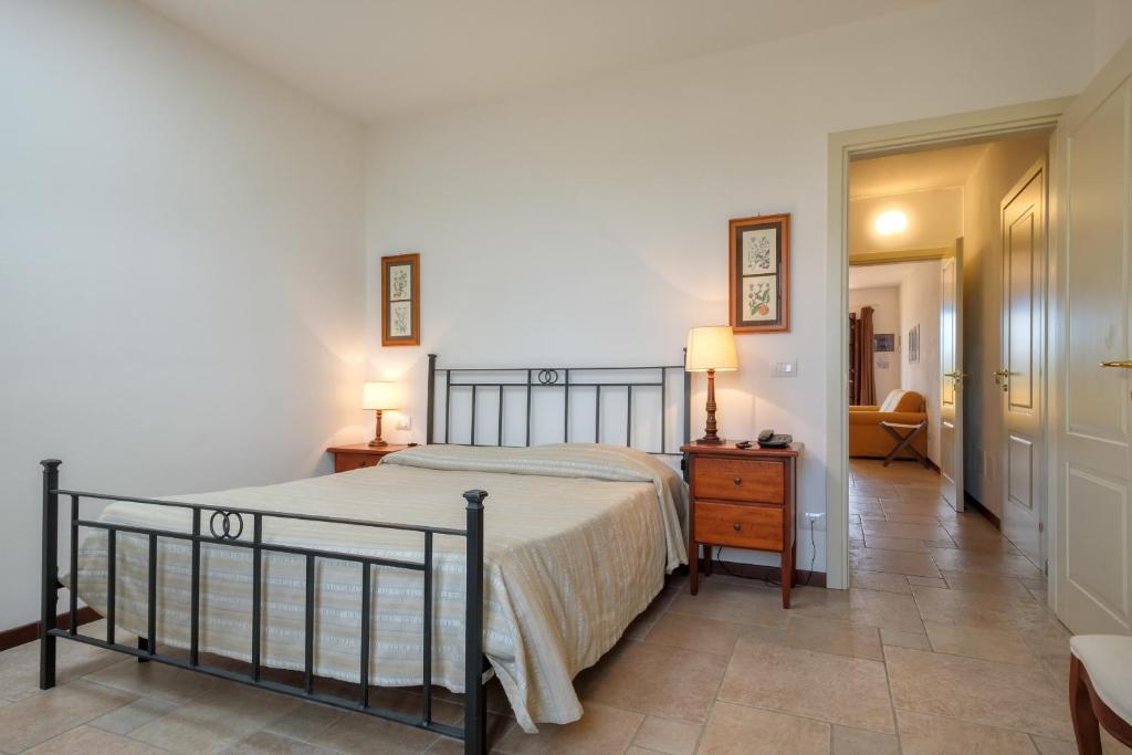 a bedroom with a bed and a table and a chair at Poggio all'Agnello Sport & Family Holidays in Populonia
