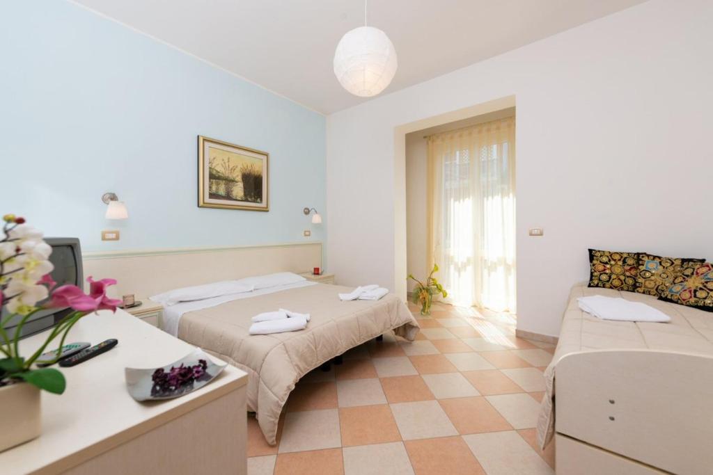 Postel nebo postele na pokoji v ubytování Hotel Bruna