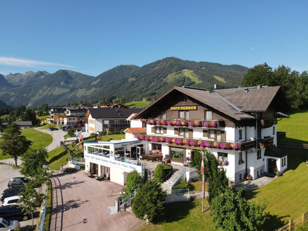 an aerial view of a hotel with mountains in the background at Hotel-Café Perner in Schladming