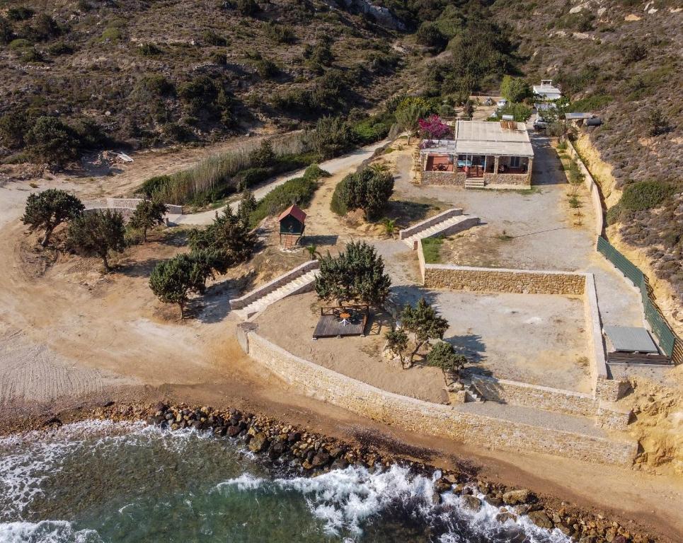 an aerial view of a house on a beach at Ktima Sfakia in Kefalos
