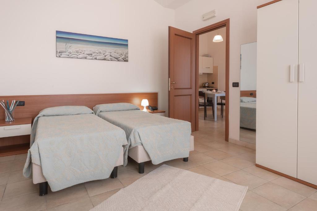 Postel nebo postele na pokoji v ubytování Residence Le Fontane