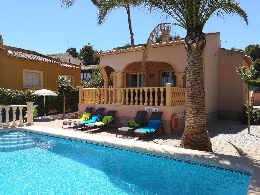 a villa with a swimming pool in front of a house at 0309 Monteverde Nectar in Balcon del Mar