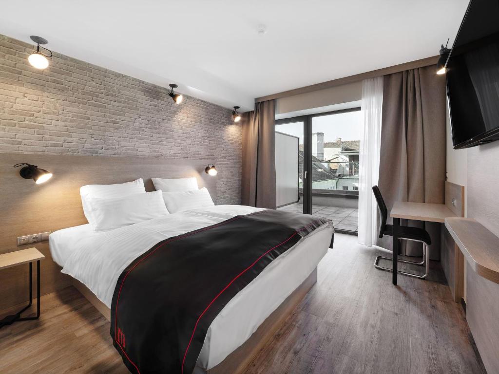 Posteľ alebo postele v izbe v ubytovaní DORMERO Hotel Budapest