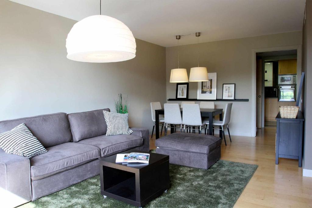 a living room with a couch and a table at Passeig de gracia sun apartament balcony 2 bedroo in Barcelona