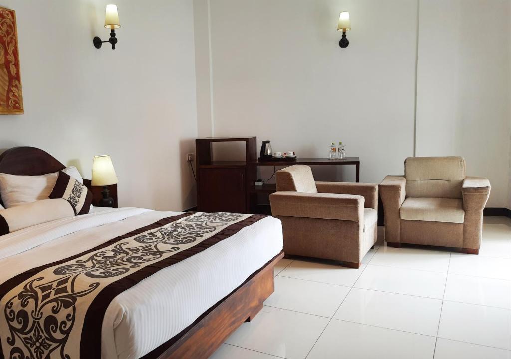 Postel nebo postele na pokoji v ubytování Royal Kandyan Hotel