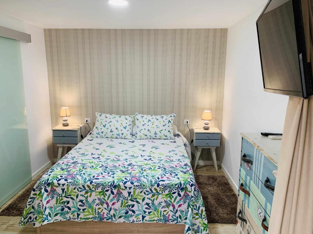 a bedroom with a bed and two night stands at Apartamento Playa de Mendez in Alcalá