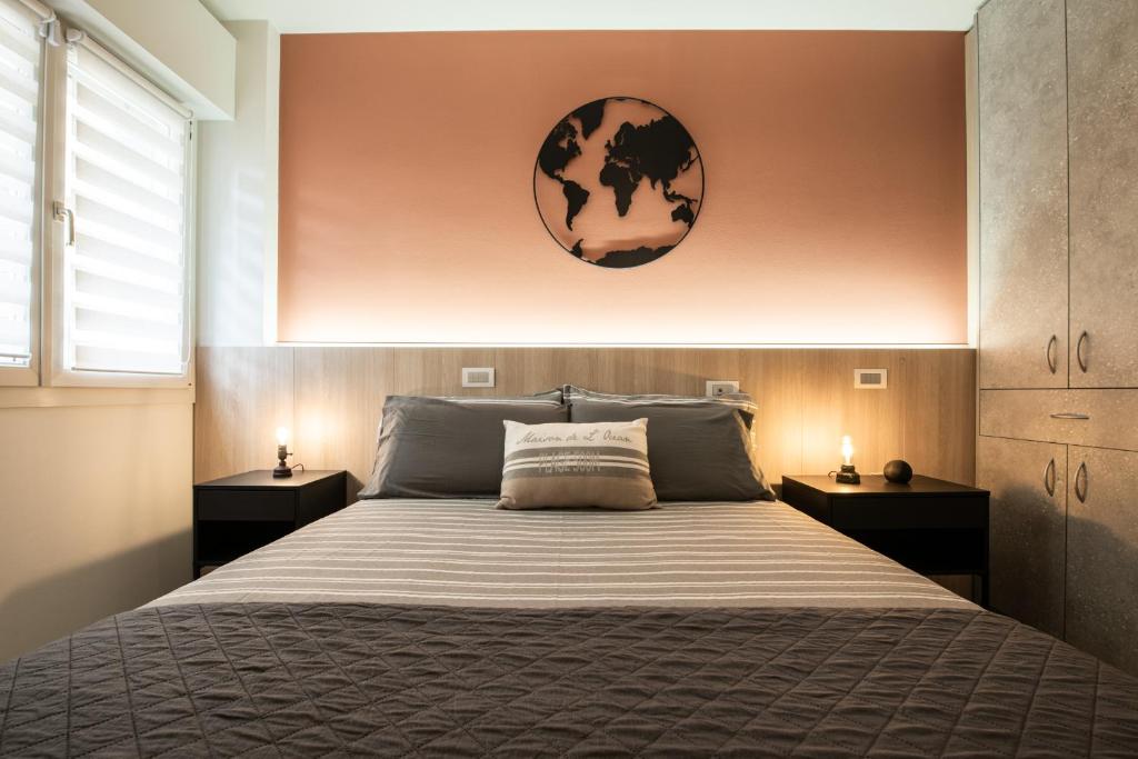a bedroom with a large bed with two night stands at Renzi 23 in Cattolica